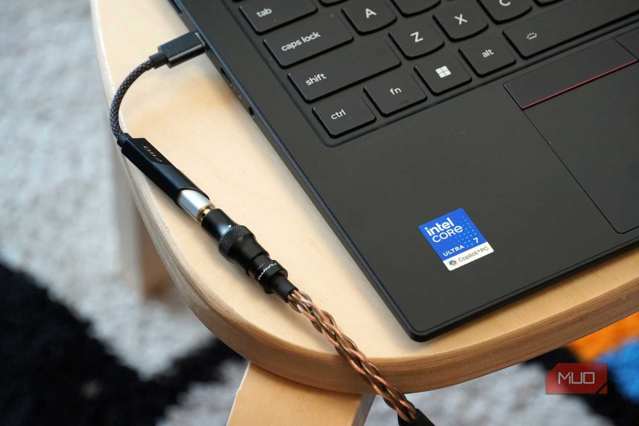 A Fiio KA11 USB-C DAC plugged into a Lenovo laptop.