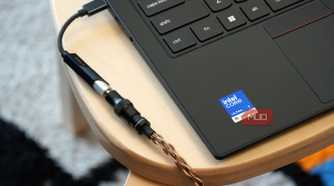 A Fiio KA11 USB-C DAC plugged into a Lenovo laptop.