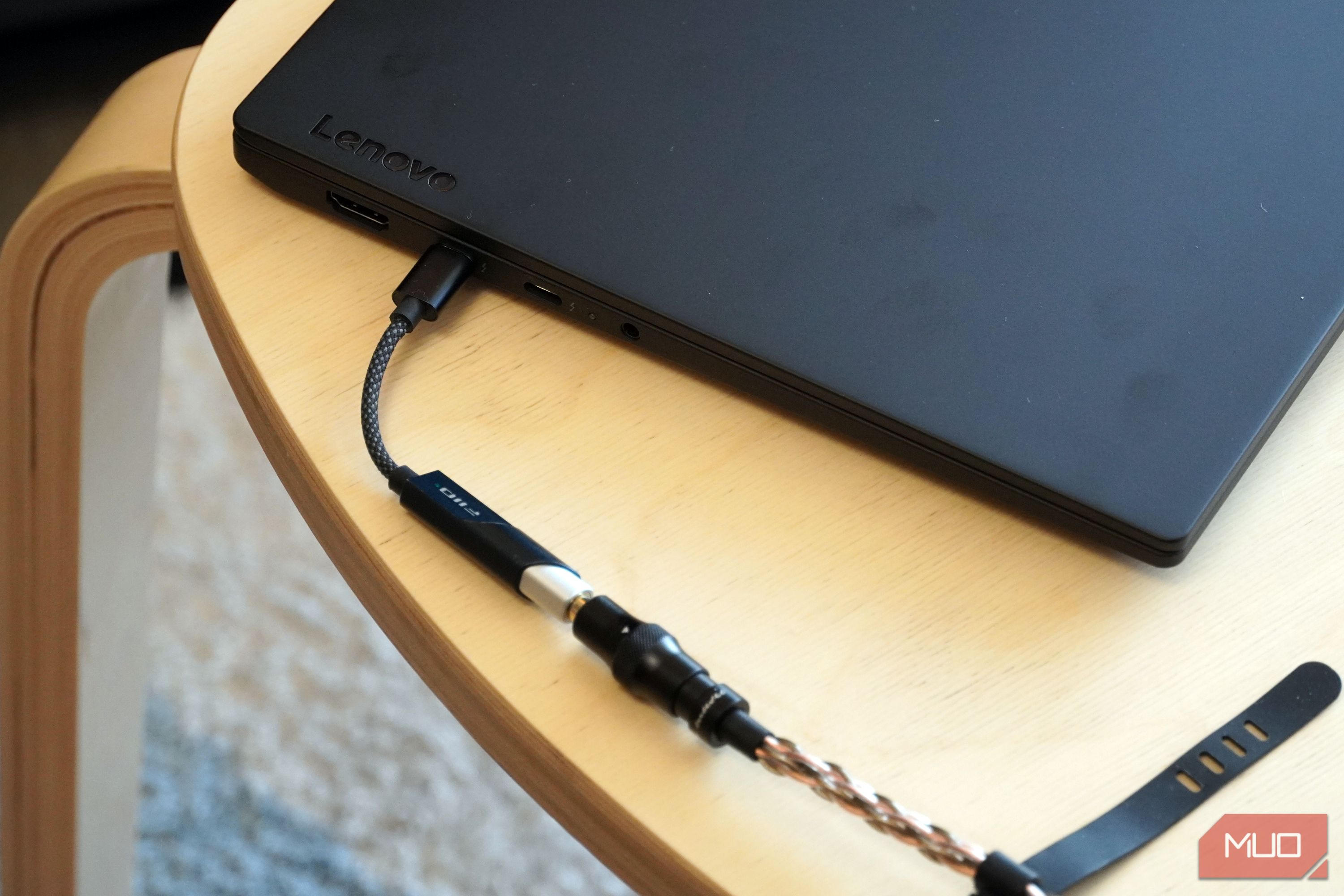 A Fiio KA11 USB-C DAC plugged into a Lenovo laptop.