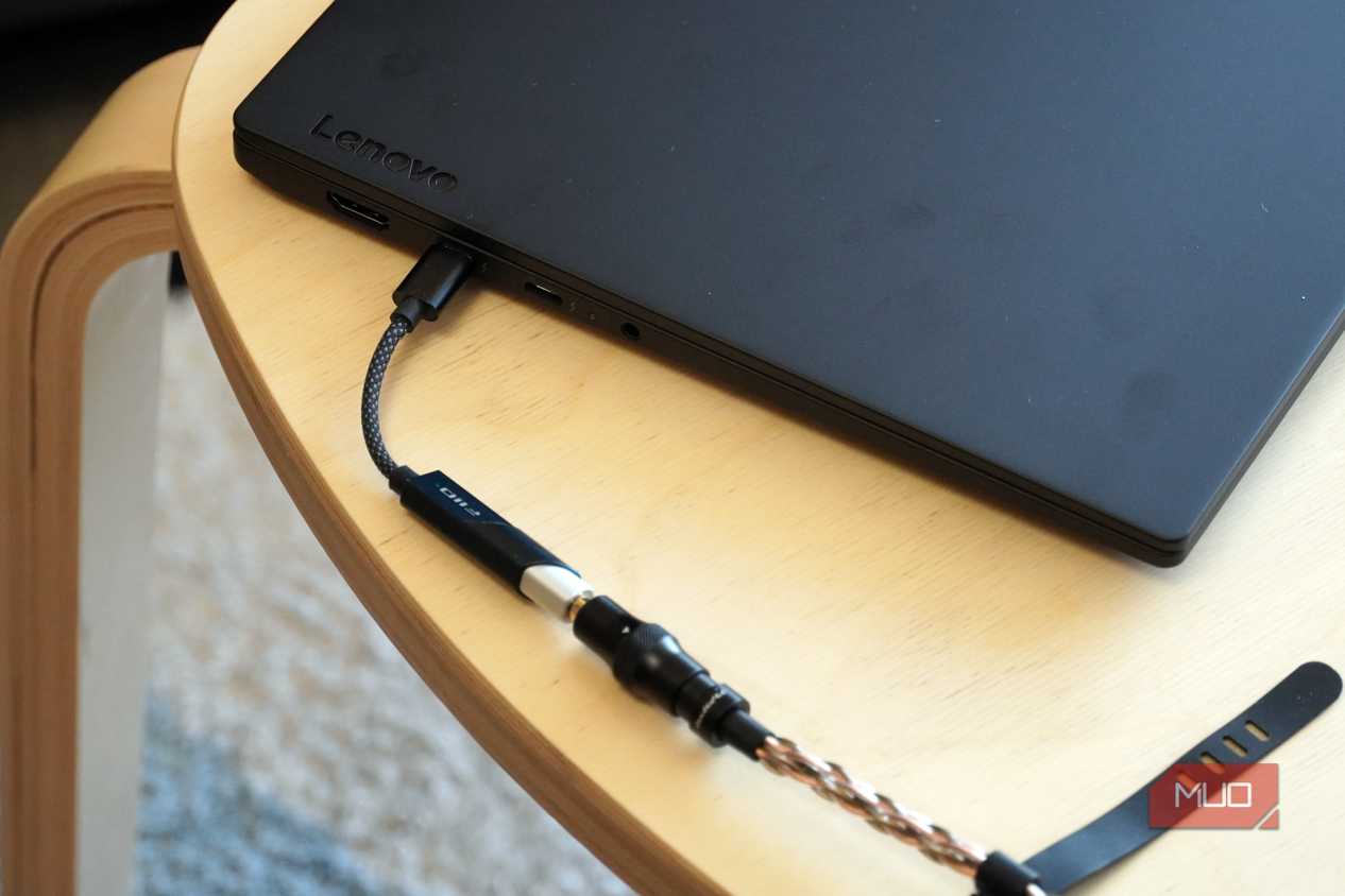 A Fiio KA11 USB-C DAC plugged into a Lenovo laptop.