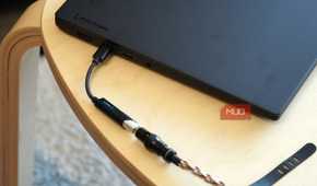 A Fiio KA11 USB-C DAC plugged into a Lenovo laptop.
