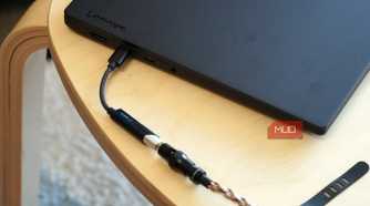 A Fiio KA11 USB-C DAC plugged into a Lenovo laptop.