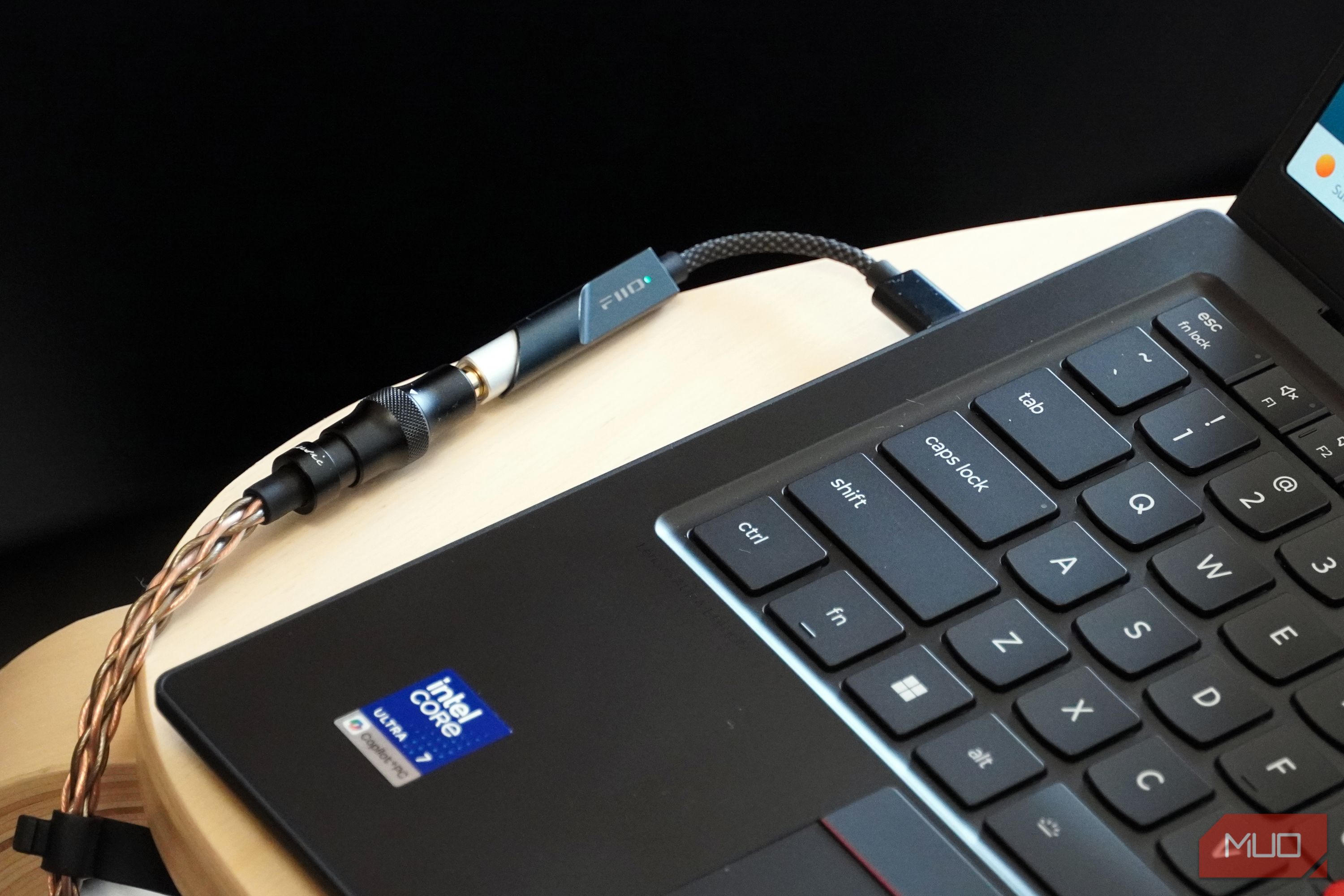 A Fiio KA11 USB-C DAC plugged into a Lenovo laptop.