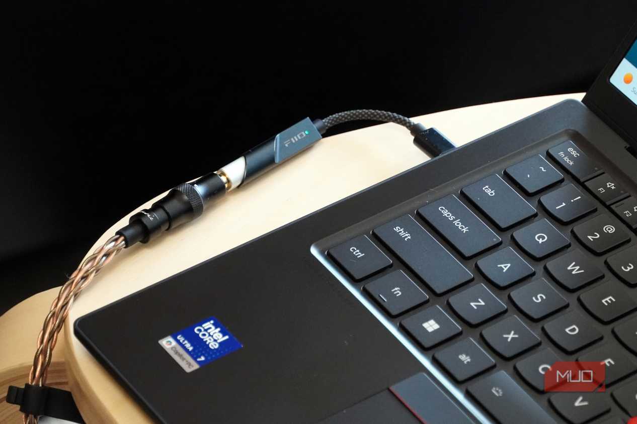 A Fiio KA11 USB-C DAC plugged into a Lenovo laptop.