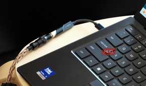 A Fiio KA11 USB-C DAC plugged into a Lenovo laptop.
