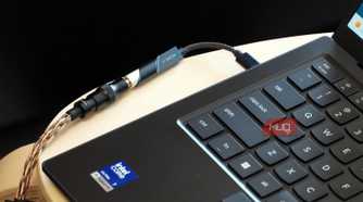 A Fiio KA11 USB-C DAC plugged into a Lenovo laptop.
