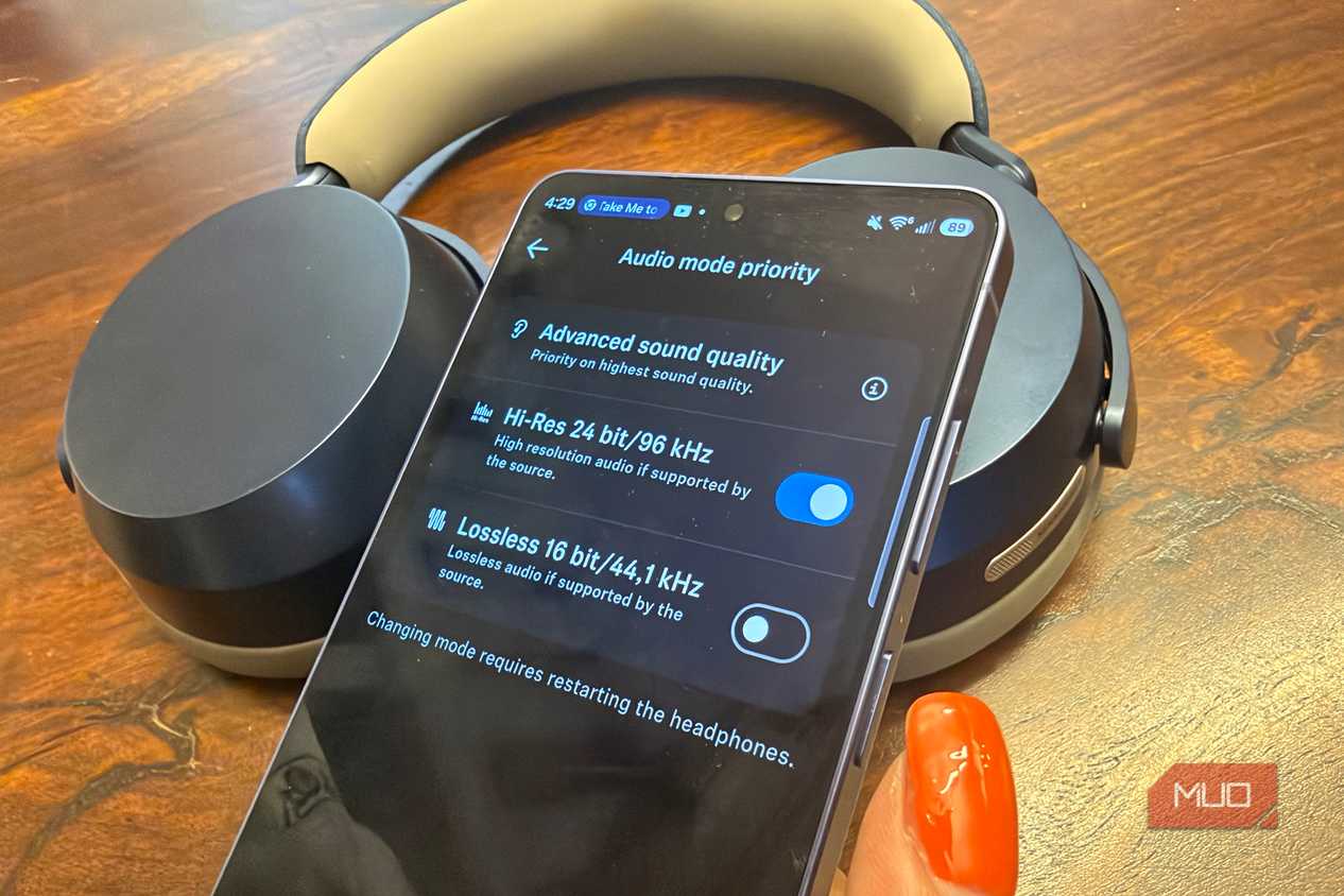 A Samsung Galaxy S26 Ultra showing Hi-Res audio with the Sennheiser Momentum 5 Wireless headphones in the background.