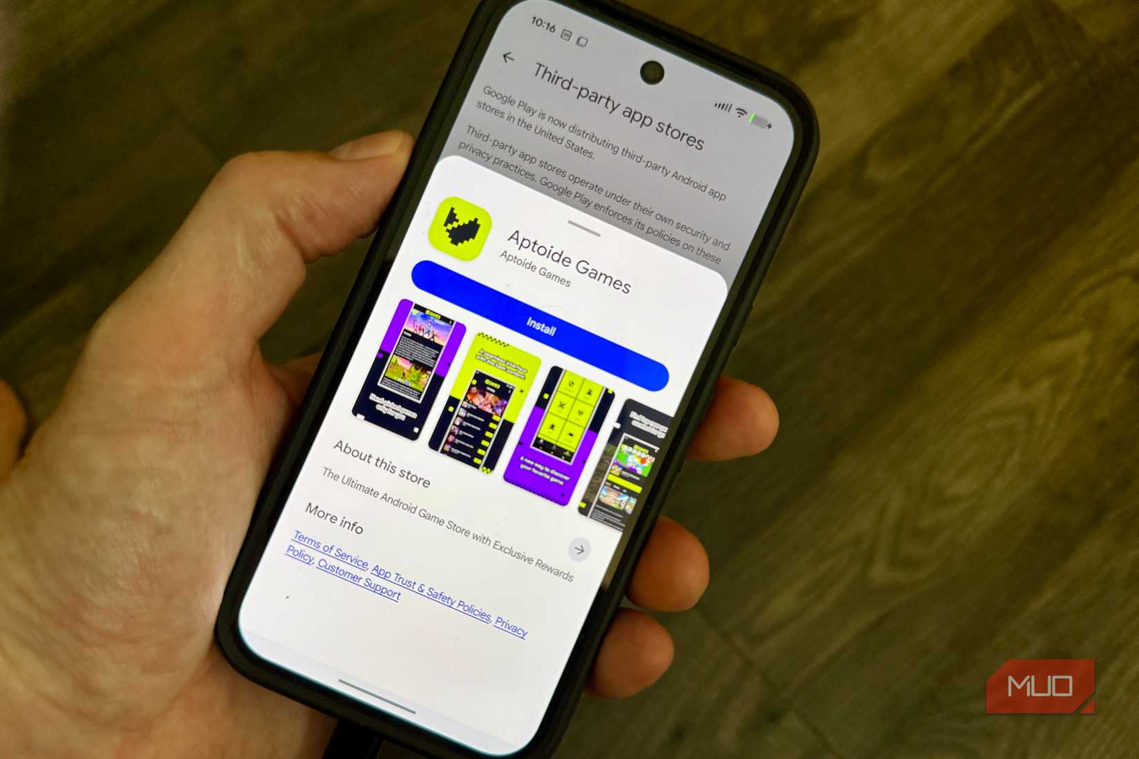 A smartphone displaying the Google Play store interface for downloading the Aptoide Games third-party app store.