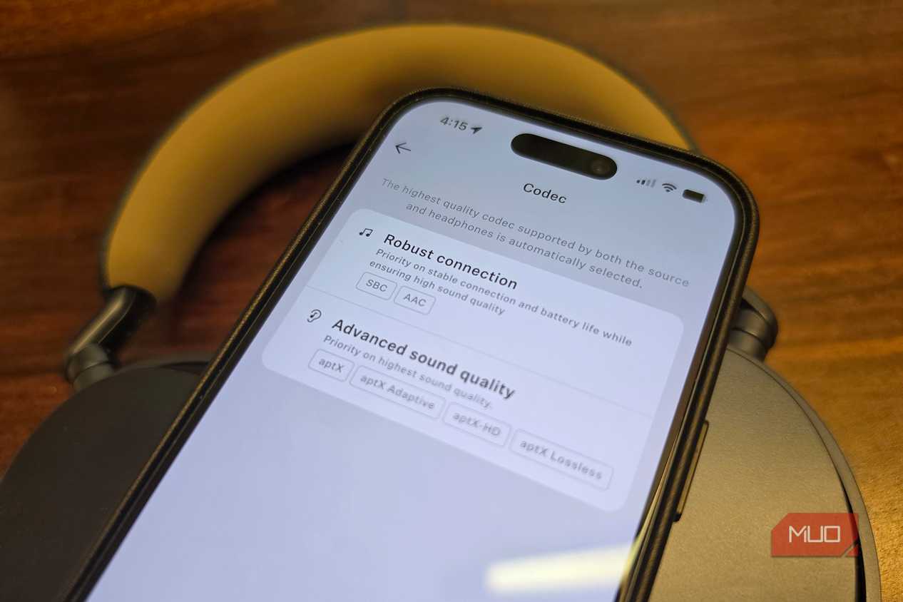 An iPhone on top of headphones showing advanced sound quality options.