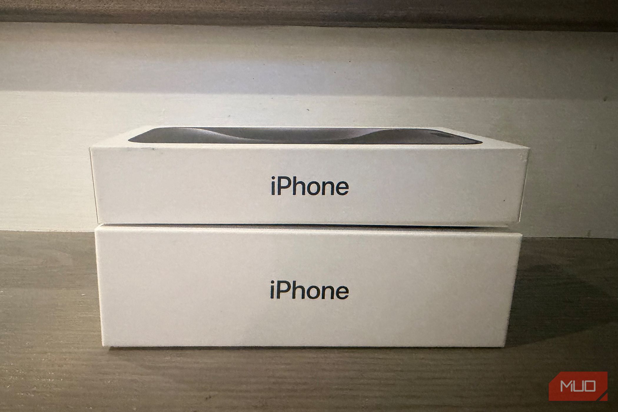 An old iPhone box under a newer one. 