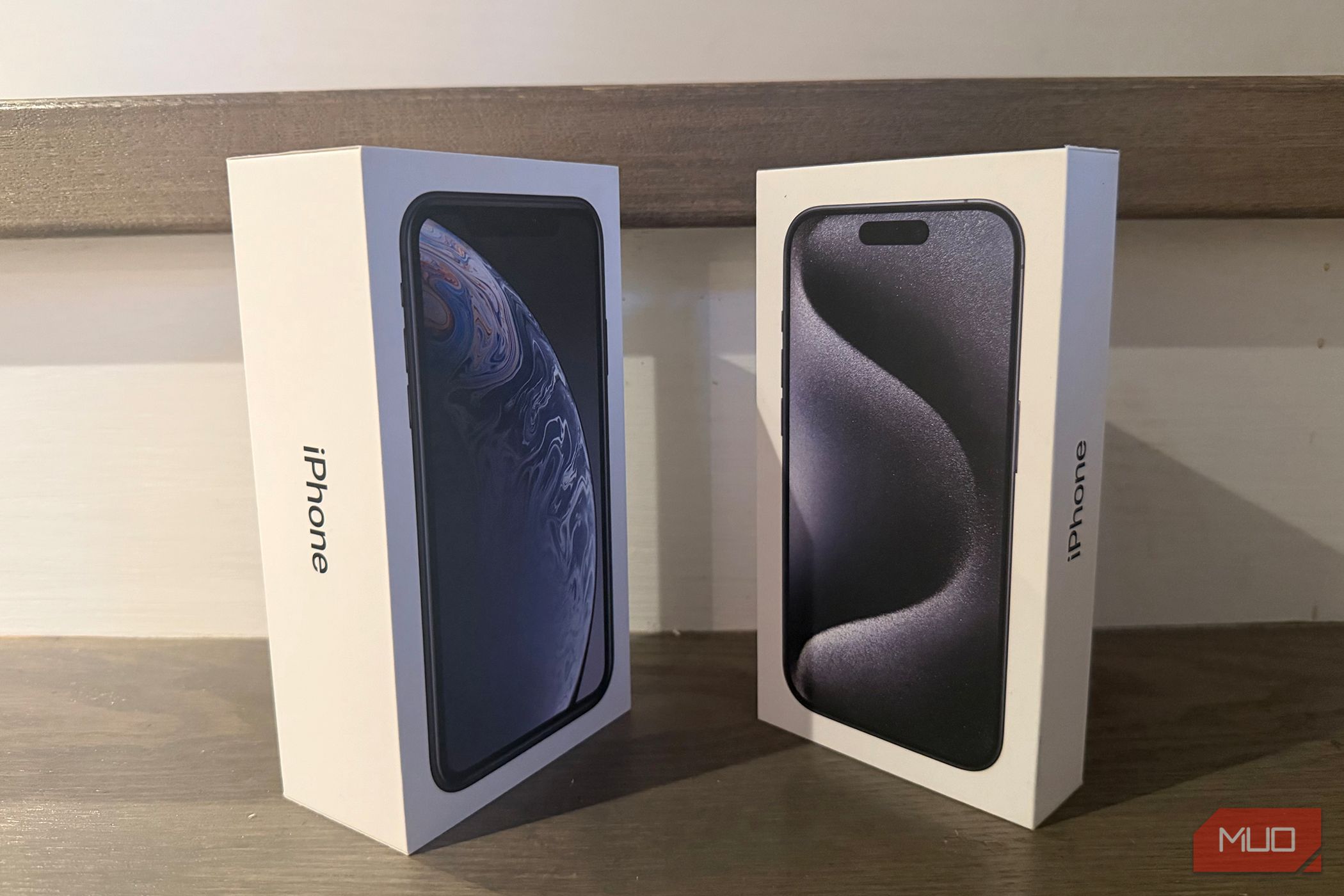 An old iPhone box beside a newer one. 