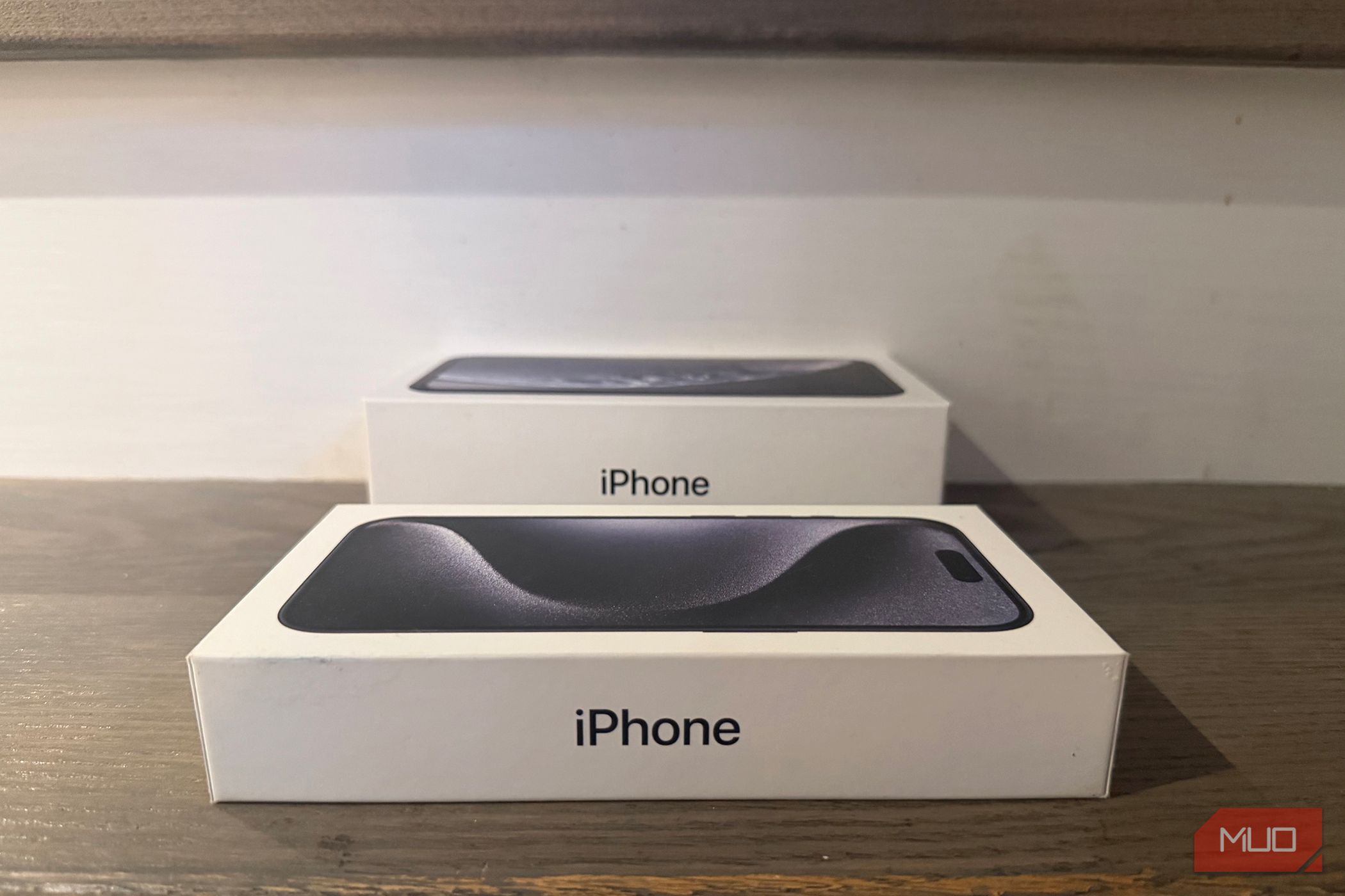 An old iPhone box beside a newer one. 