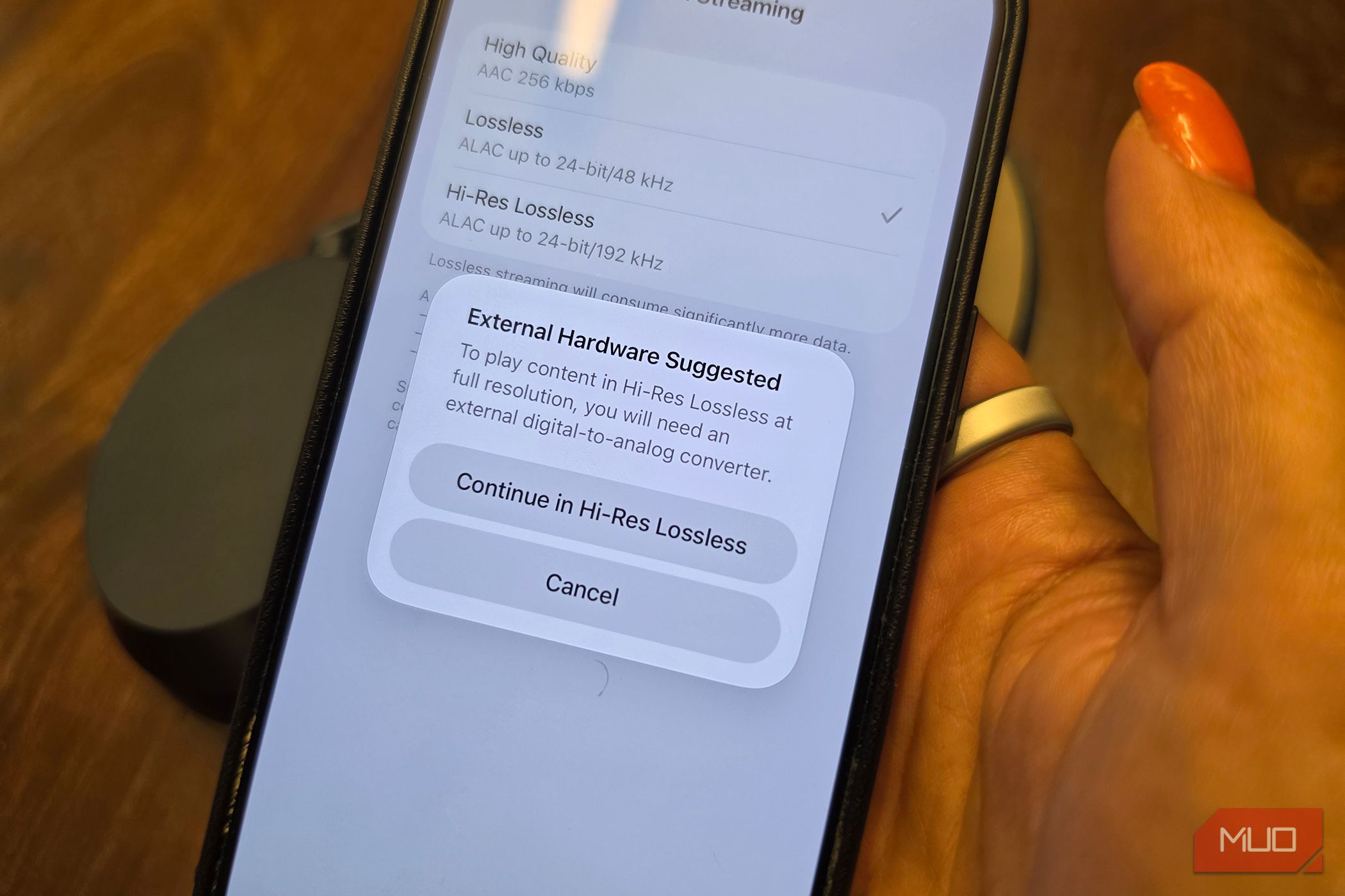 An iPhone with a pop-up showing that you need external hardware to listen in Hi-Res Lossless.