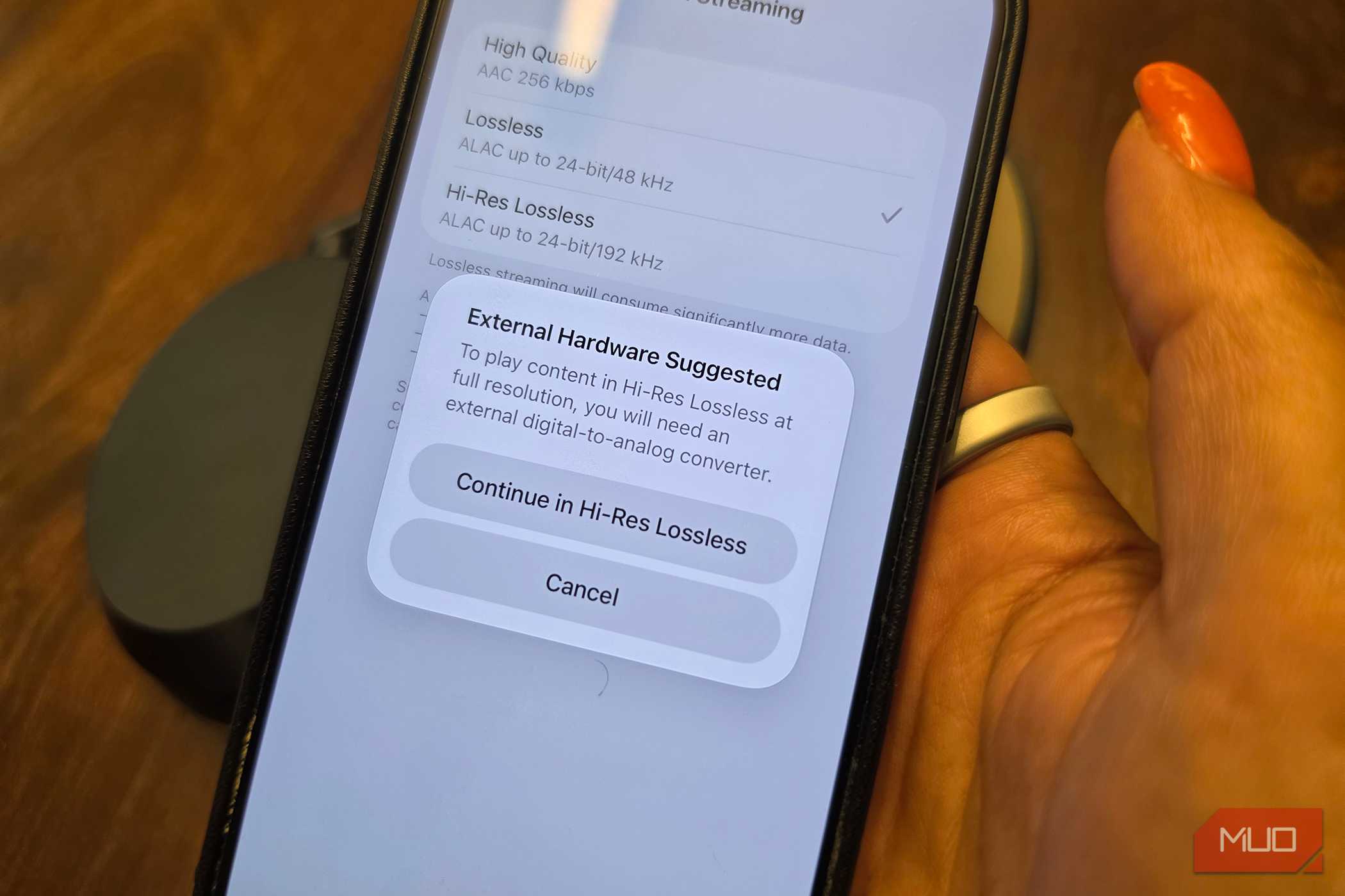 An iPhone with a pop-up showing that you need external hardware to listen in Hi-Res Lossless.