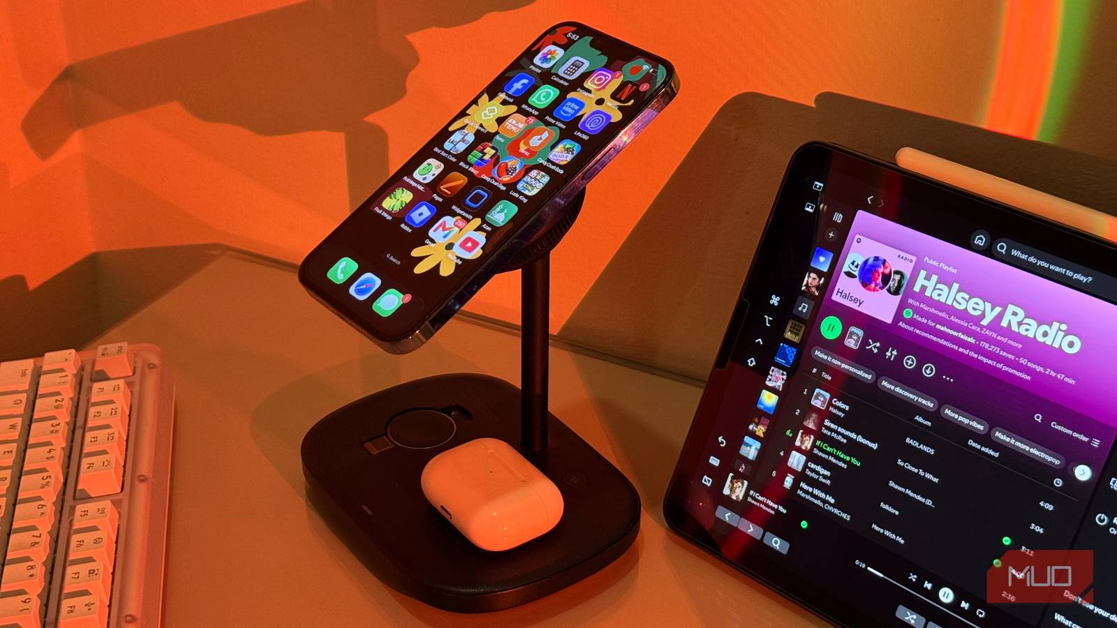 iPhone on Baseus stand with AirPods charging and iPad Spotify 2
