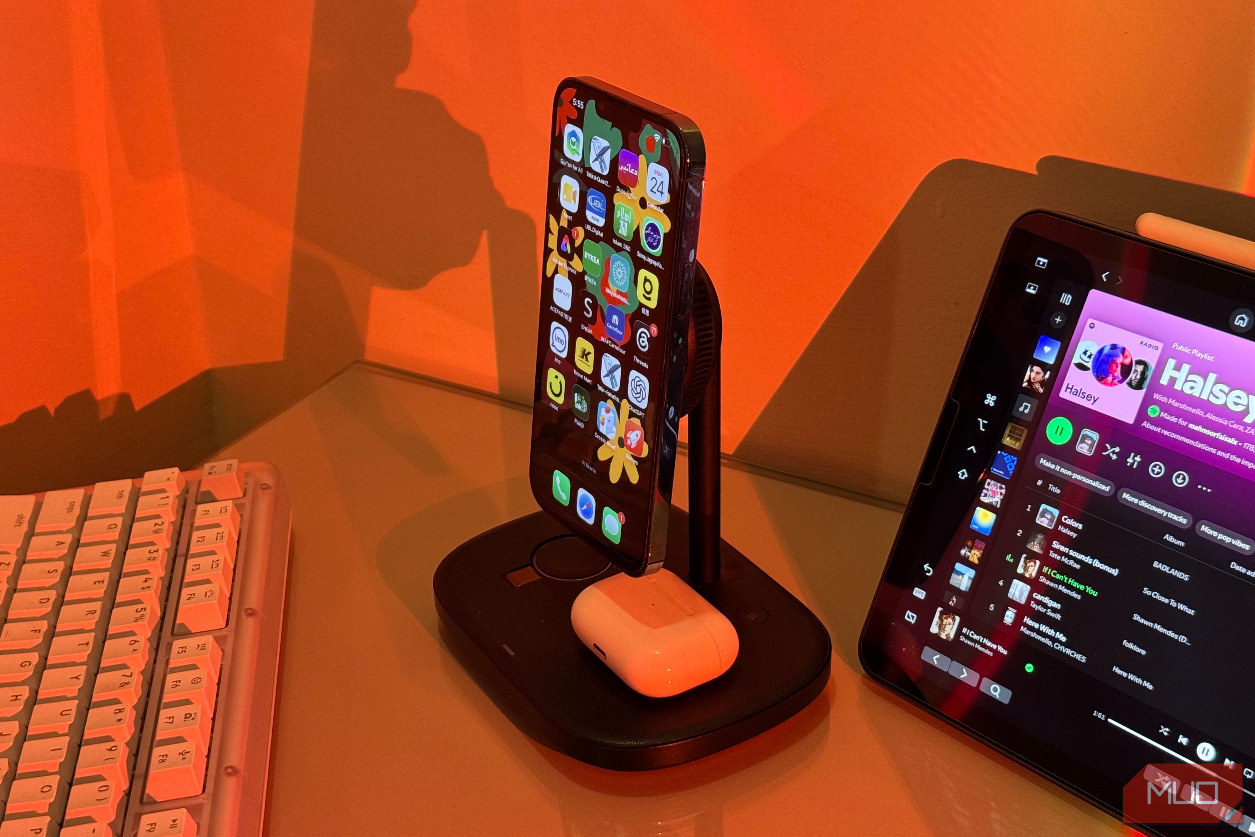 iPhone with Arabic apps on Baseus stand and AirPods 2