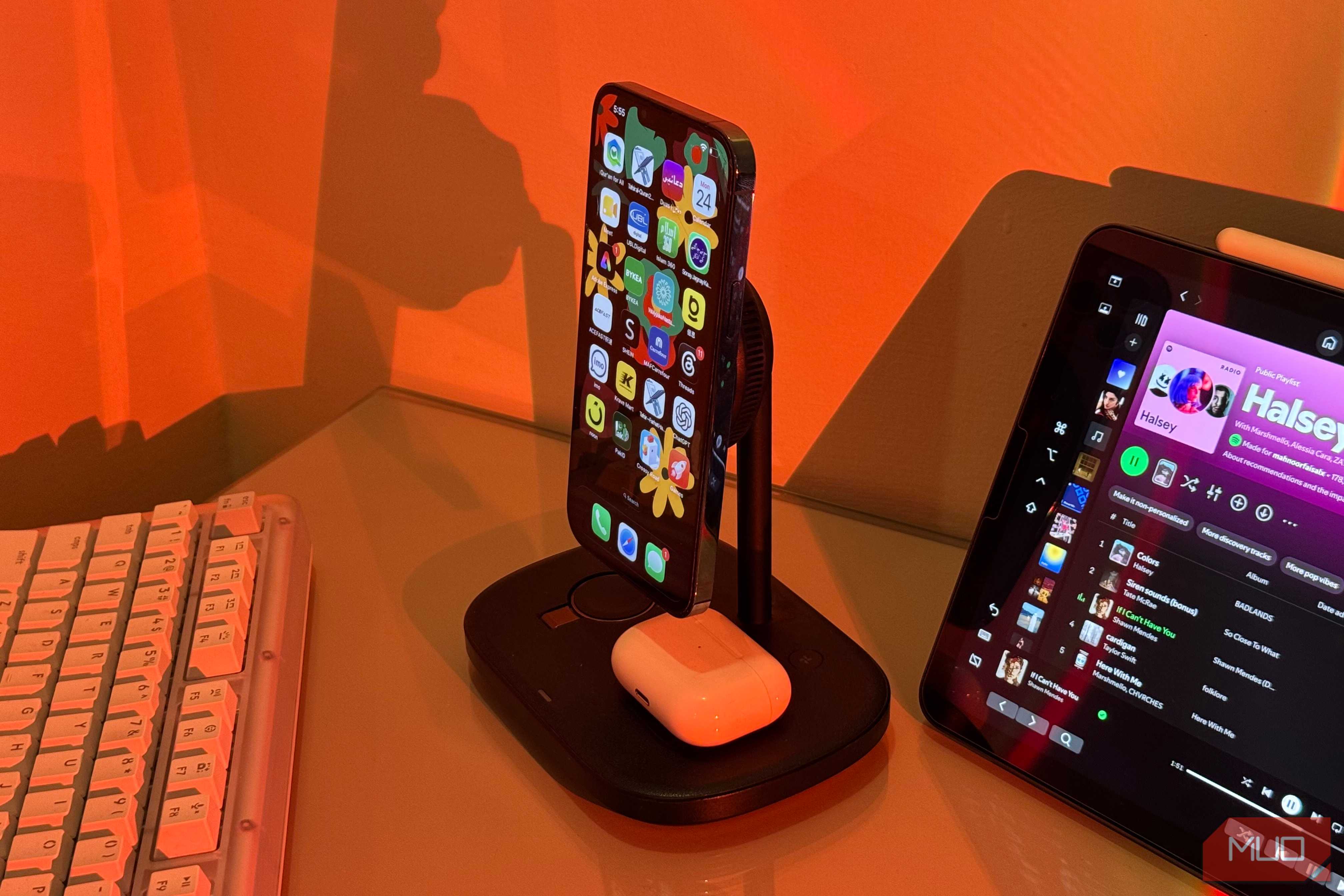 iPhone with Arabic apps on Baseus stand and AirPods 2