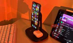 iPhone with Arabic apps on Baseus stand and AirPods 2