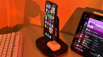 iPhone with Arabic apps on Baseus stand and AirPods 2
