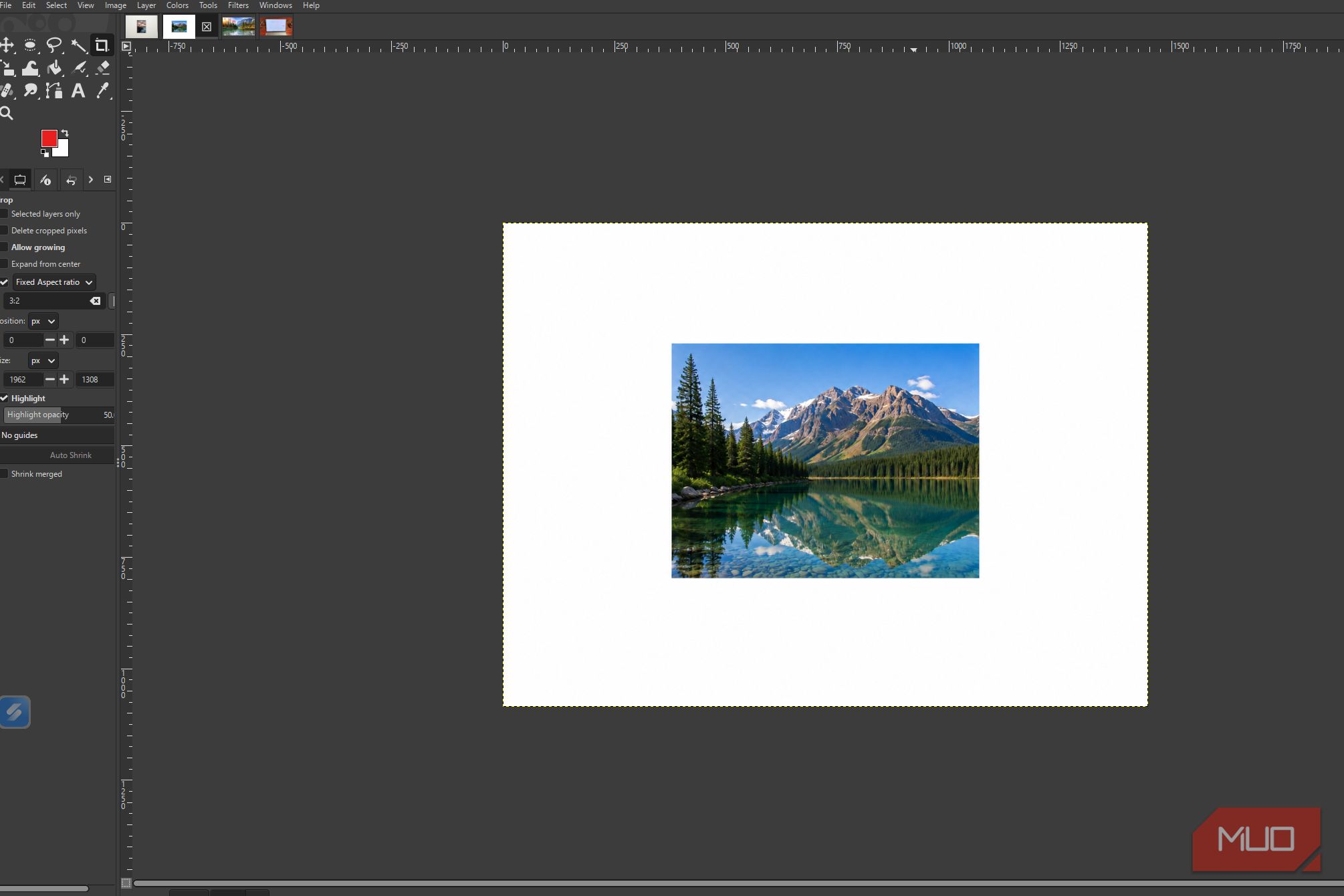 GIMP showing the original mountain lake photo before and levels adjustments are applied
