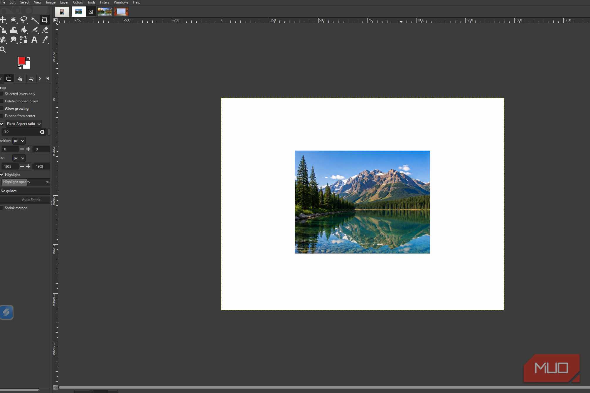 GIMP showing the original mountain lake photo before and levels adjustments are applied