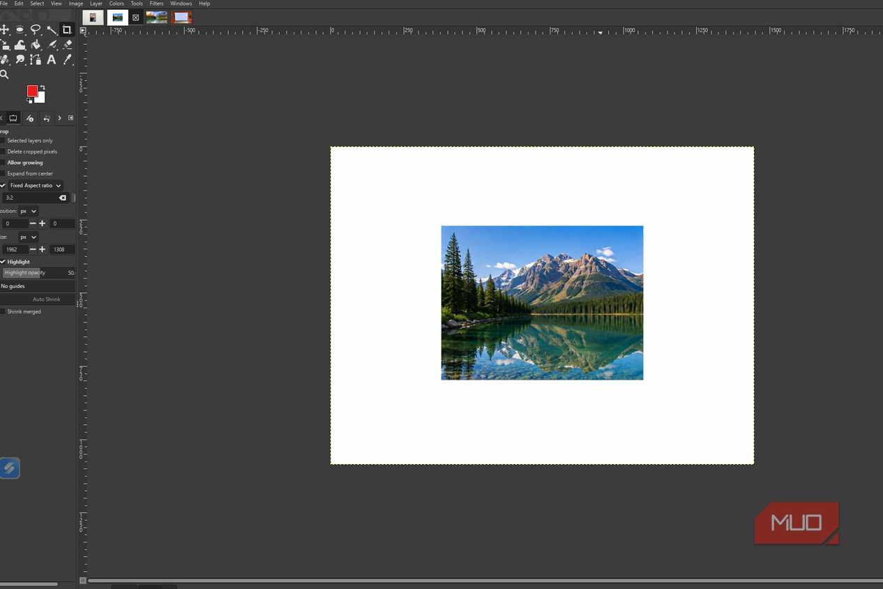 GIMP showing the original mountain lake photo before and levels adjustments are applied