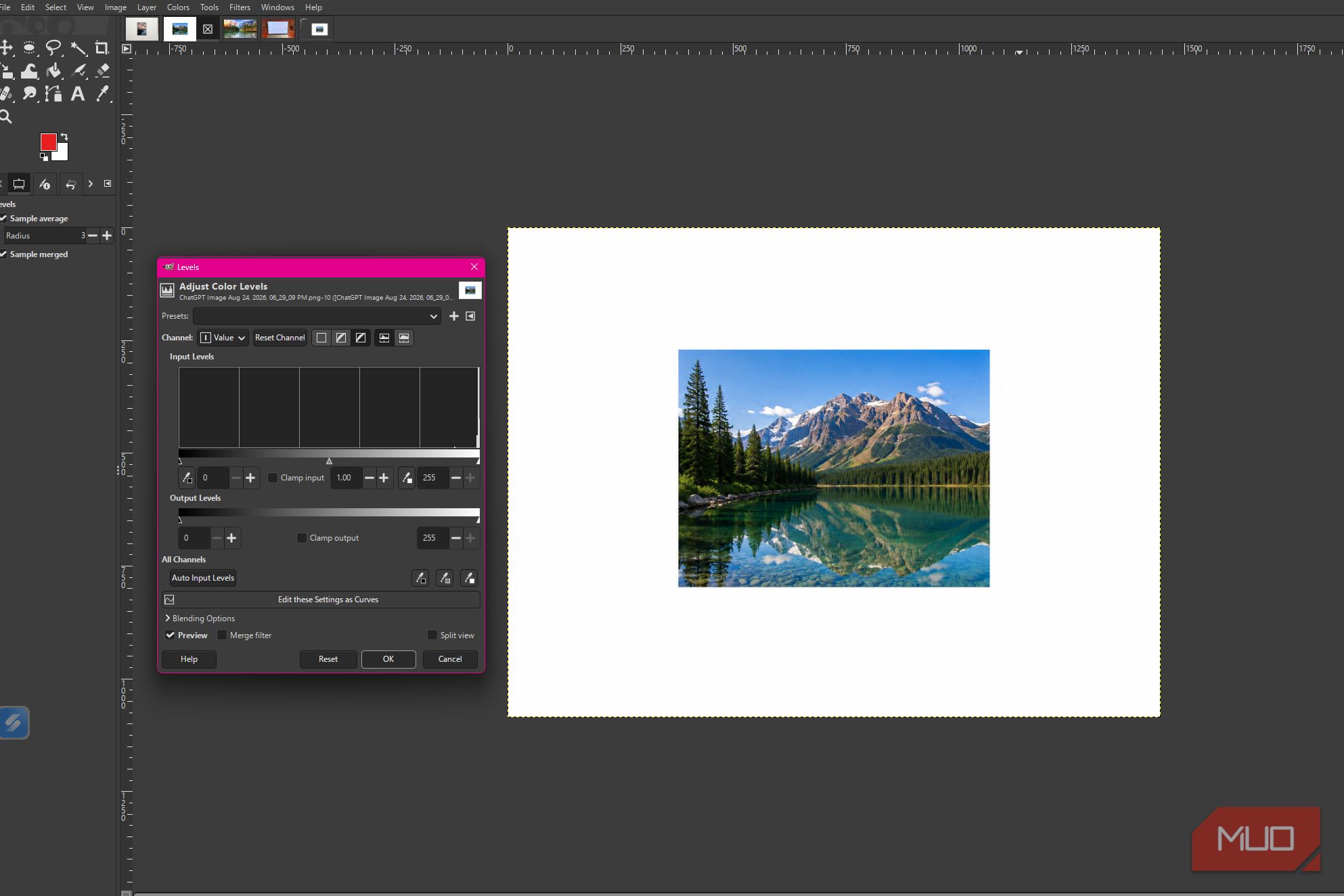 GIMP showing the levels dialog open with the mountain lake photo and the default input level settings