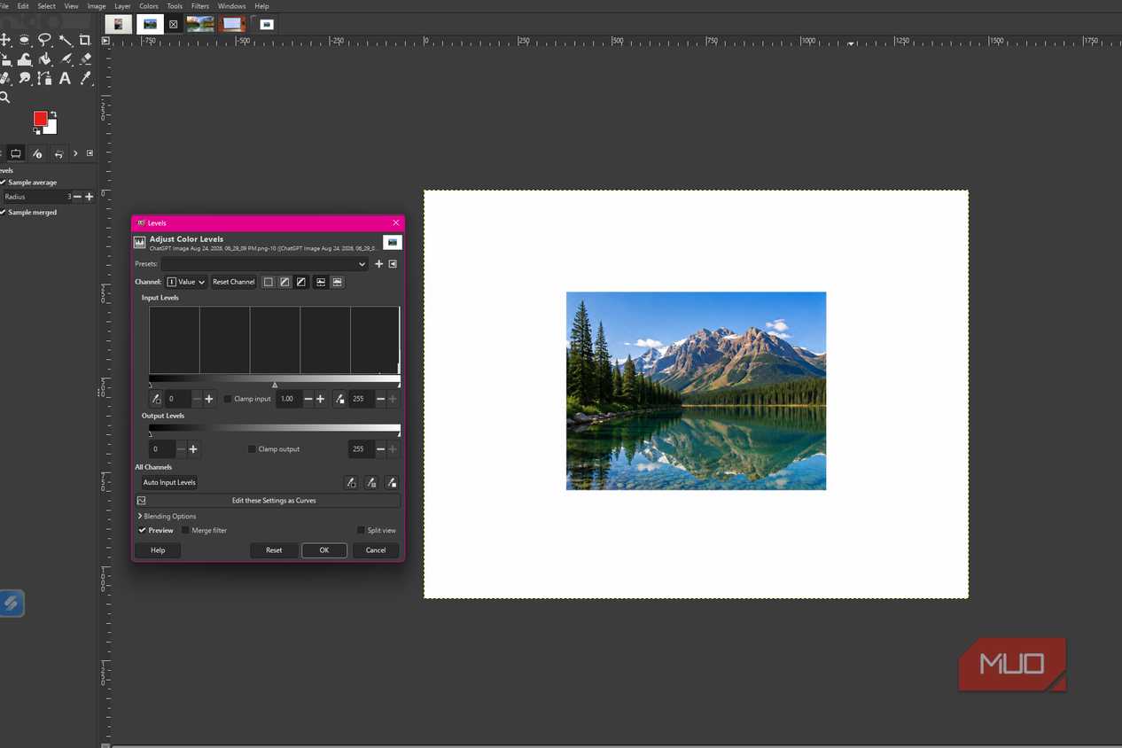 GIMP showing the levels dialog open with the mountain lake photo and the default input level settings