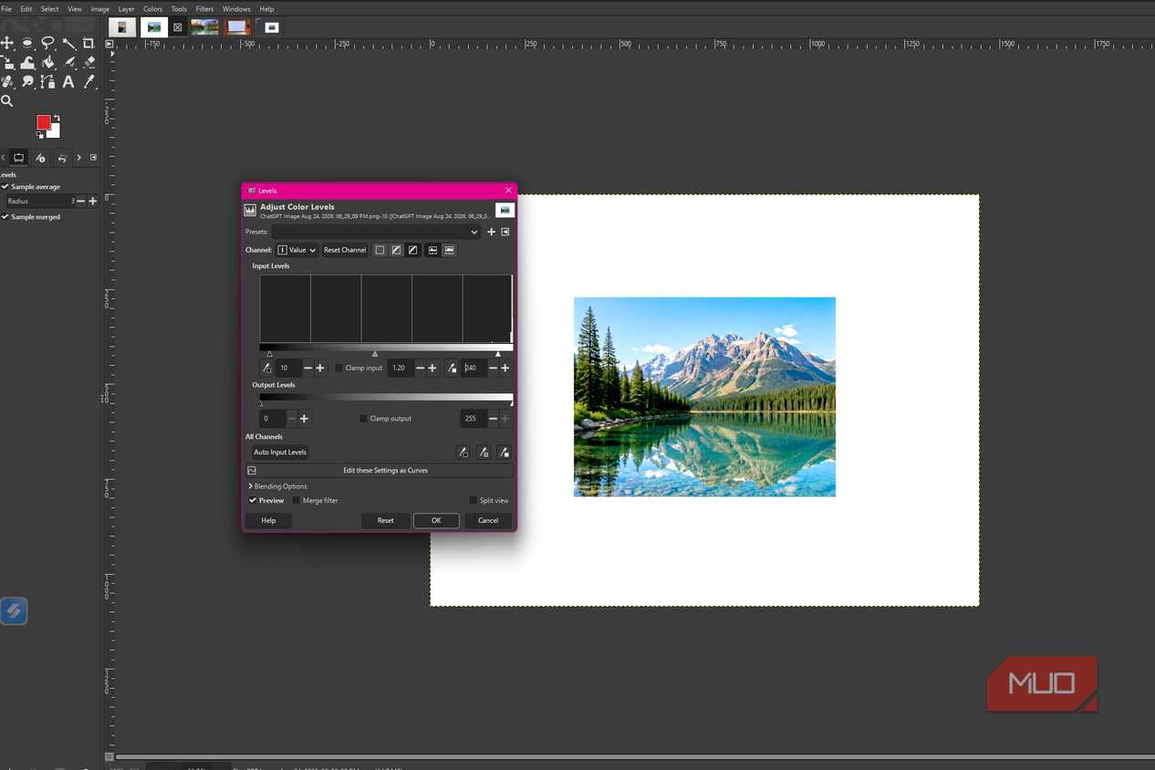 GIMP showing Levels adjustments applied to brighten the mountain lake photo and bring out more detail