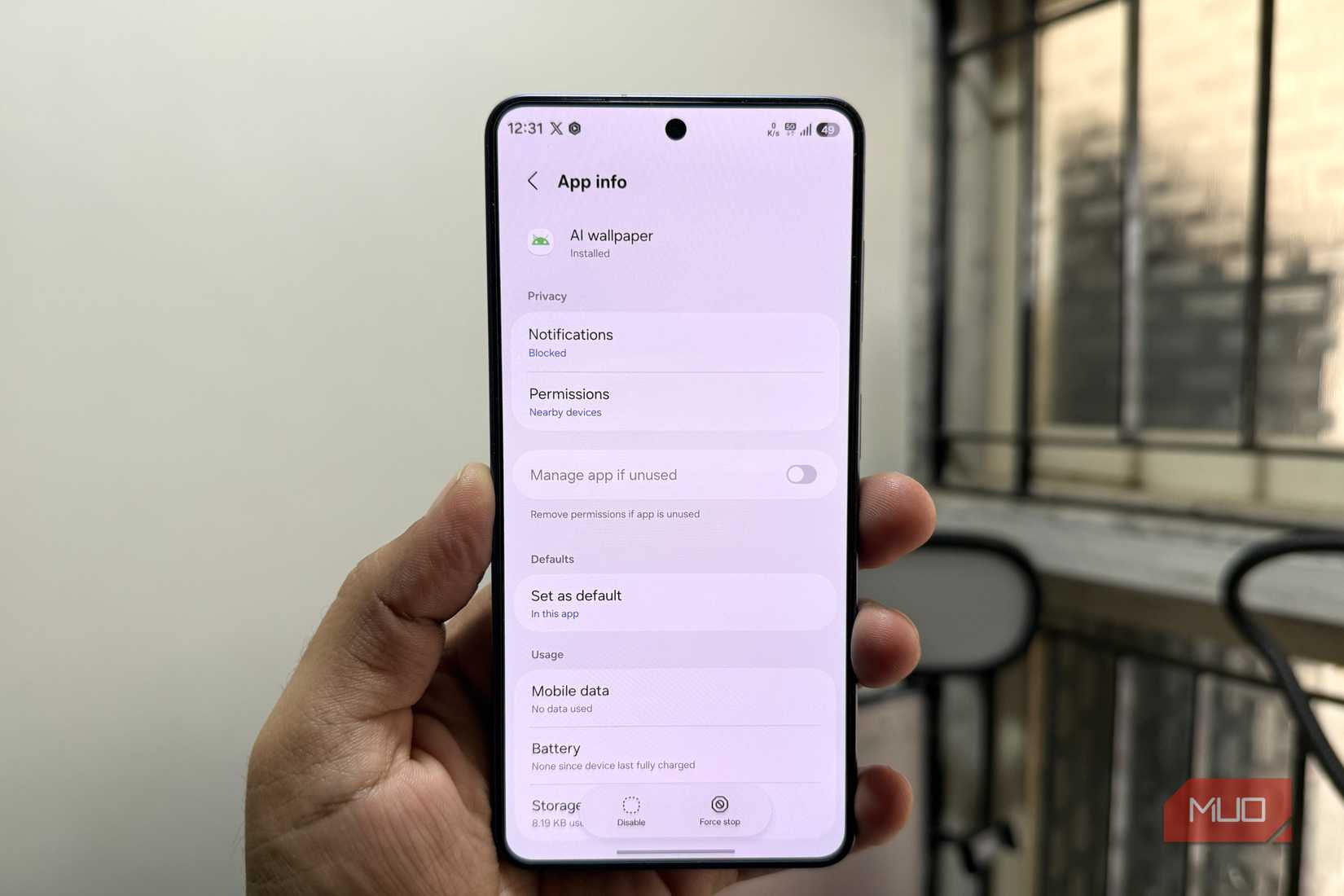 Phone in hand showing AI wallpaper app info