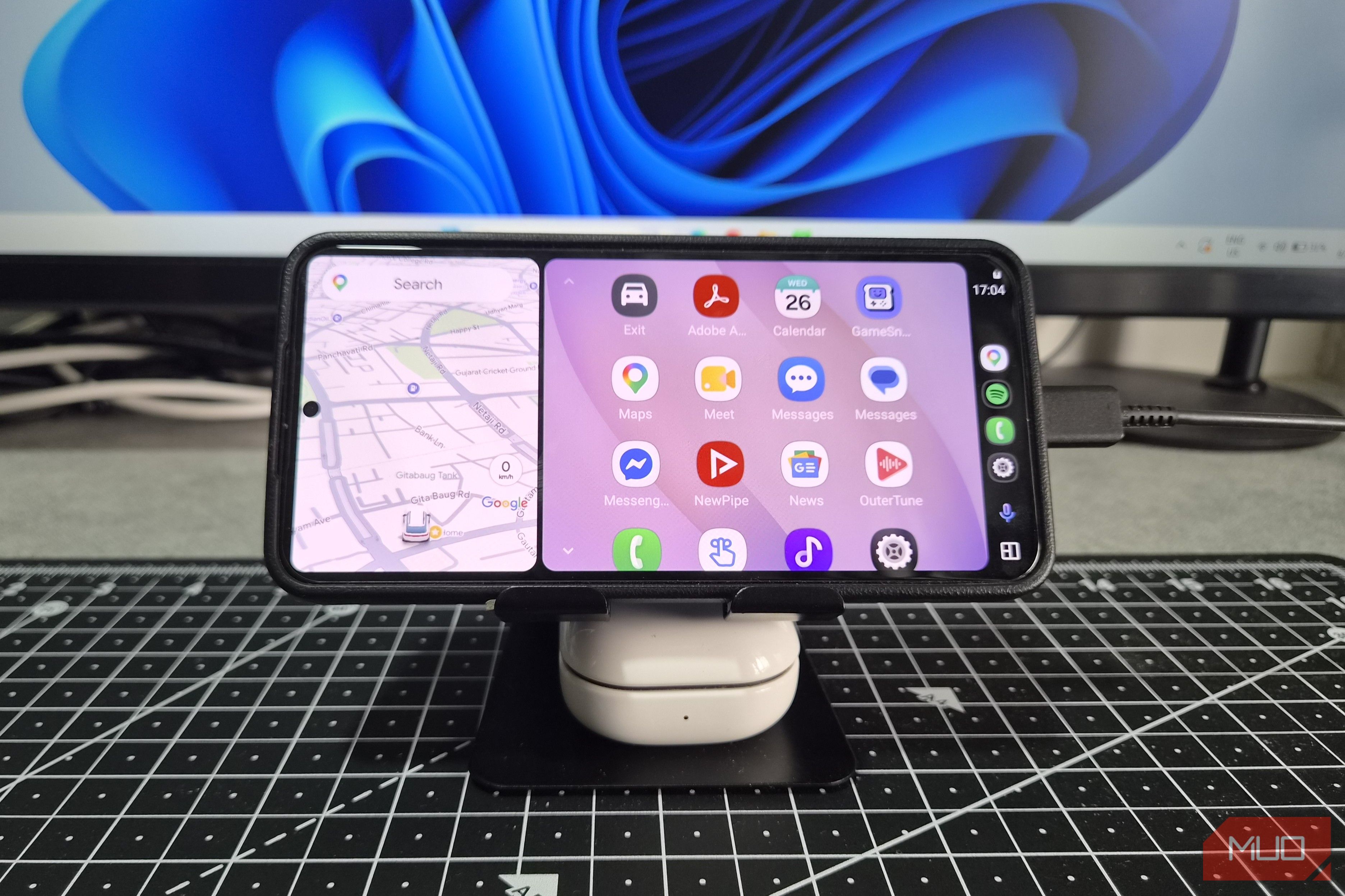 Phone mounted on a stand showing Android Auto screen