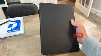rocketbook pro 2.0 closed held in hand above wooden desk
