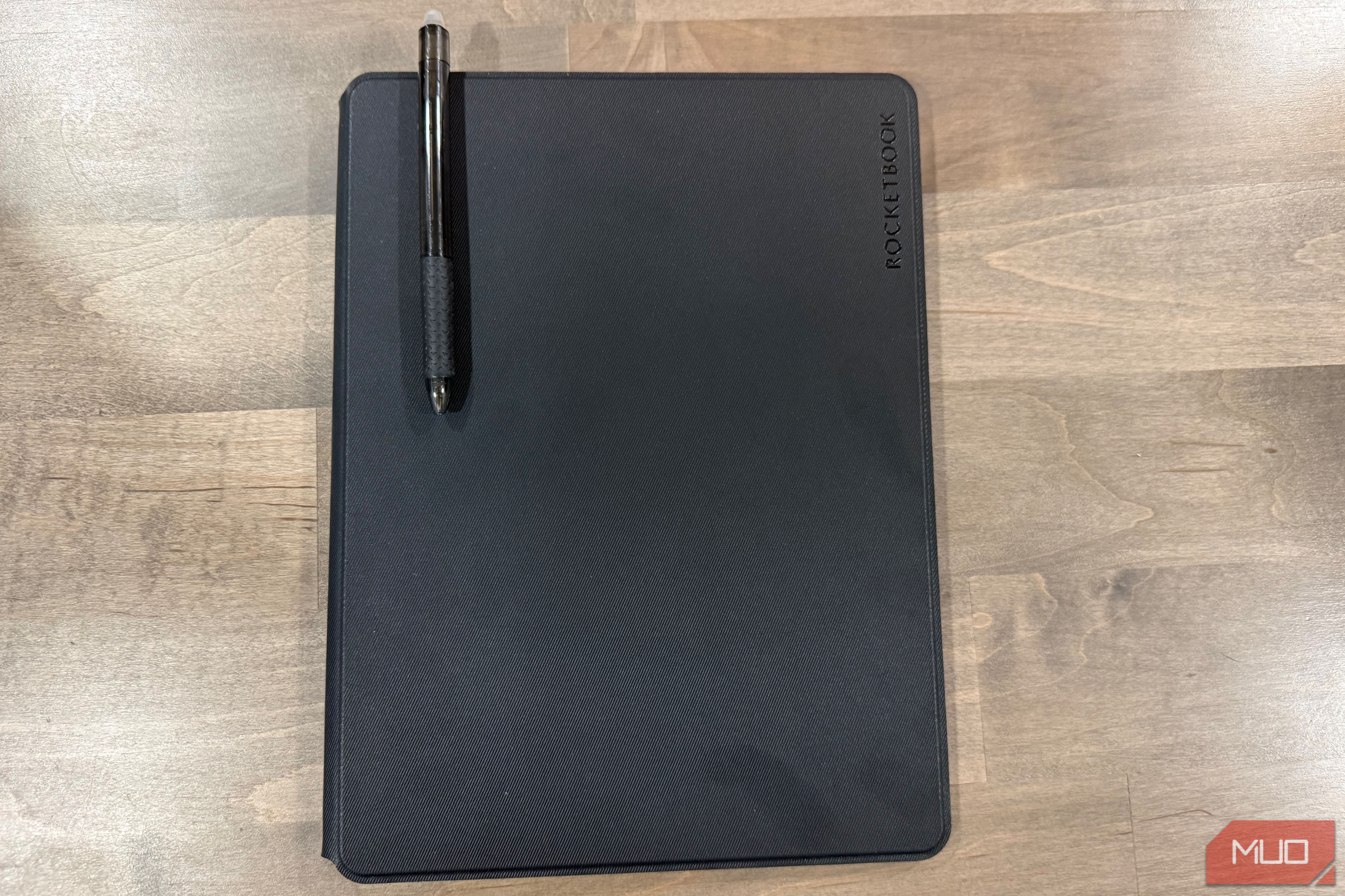 rocketbook pro 2.0 closed with black pen resting on cover