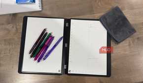 rocketbook pro 2.0 open flat with colorful erasable pens and microfiber cloth