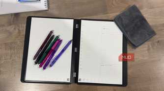 rocketbook pro 2.0 open flat with colorful erasable pens and microfiber cloth