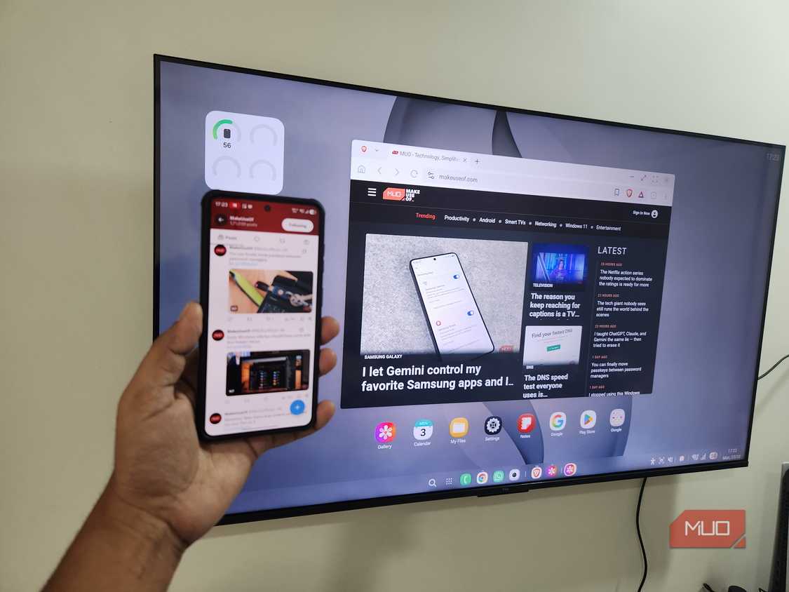 Samsung DeX on TV and Galaxy S26 phone in hand