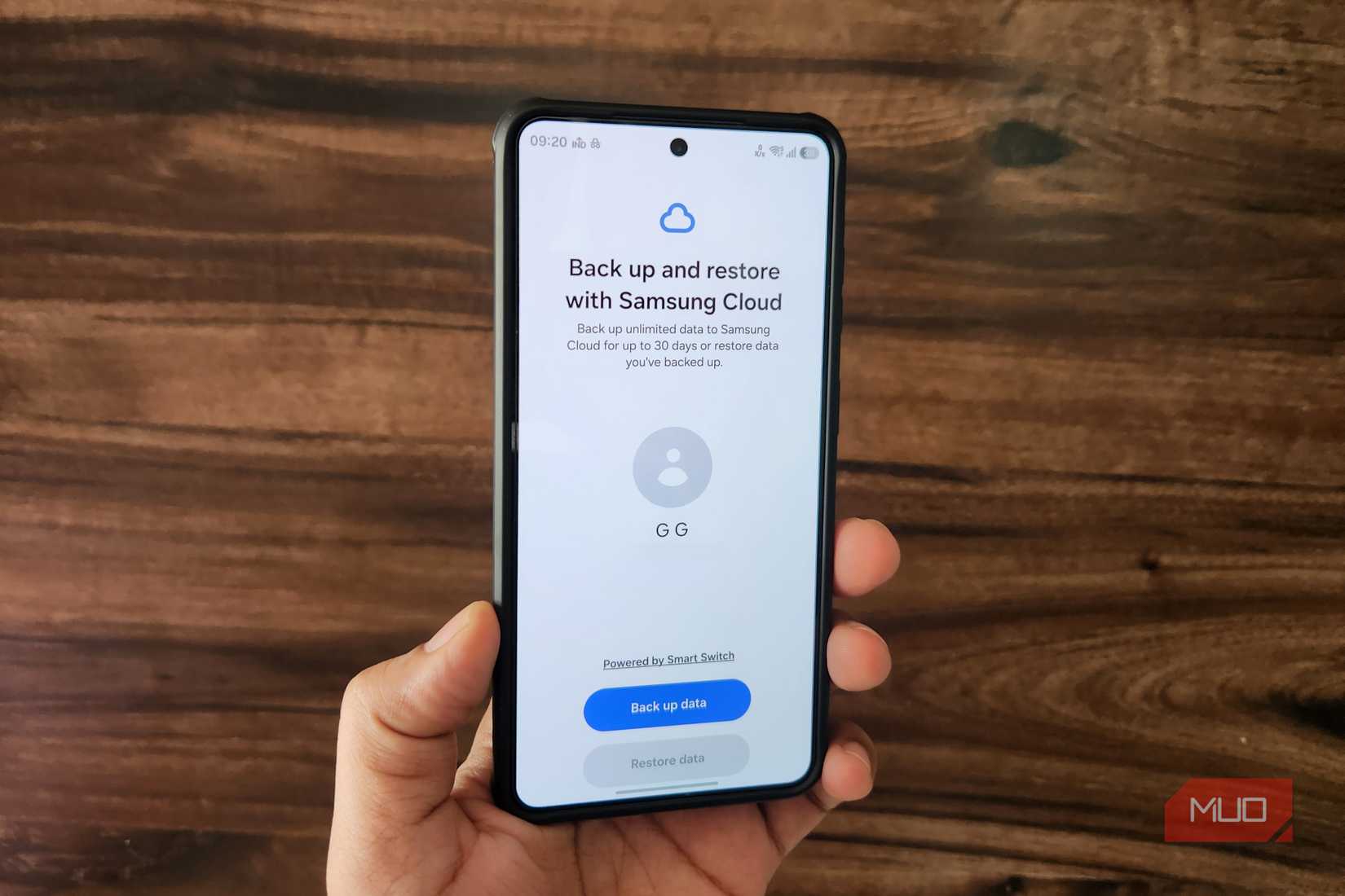 Samsung phone in hand showing backup menu