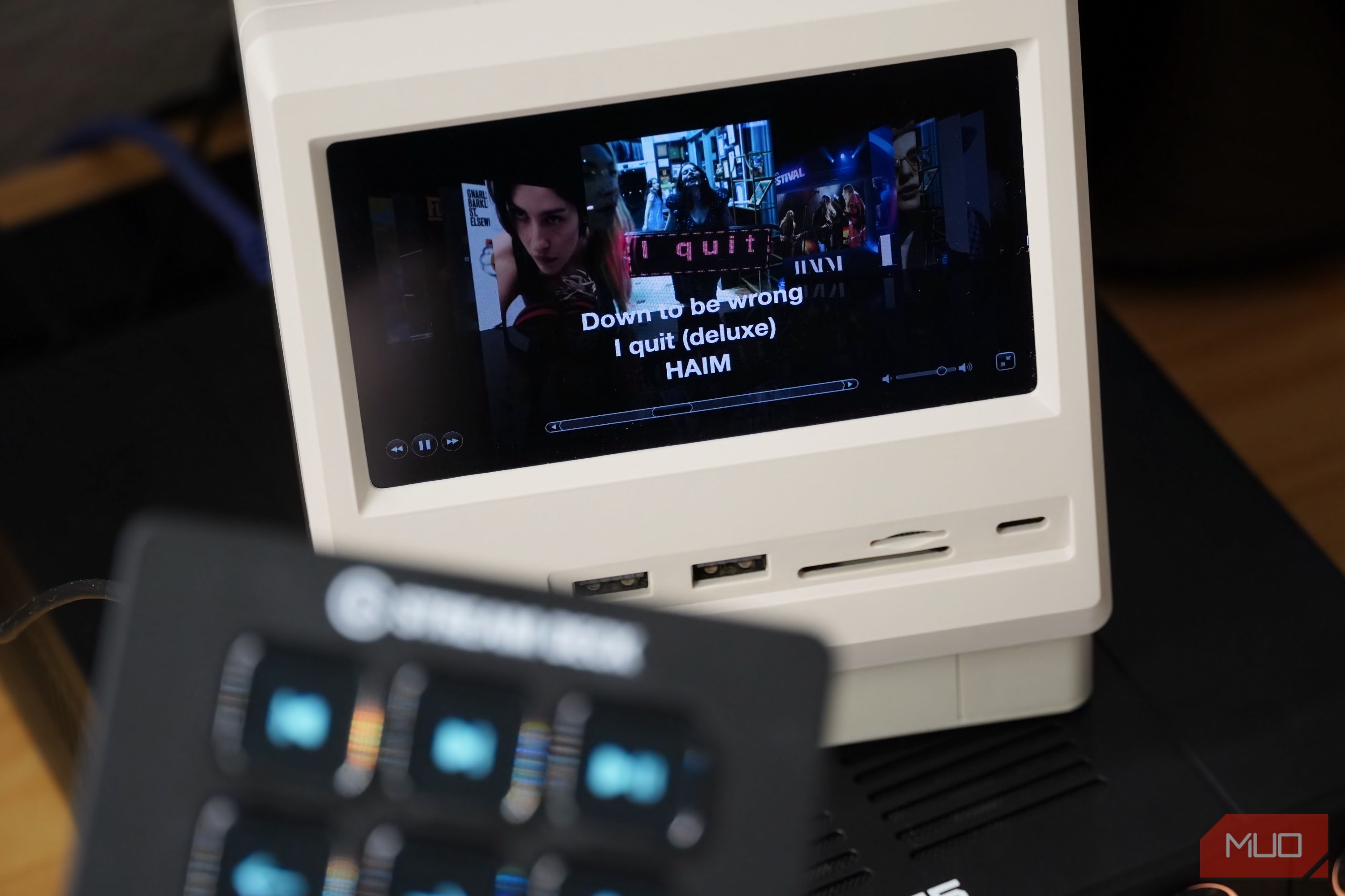 Cover Flow in iTunes with a blurred Stream Deck Mini in the foreground.