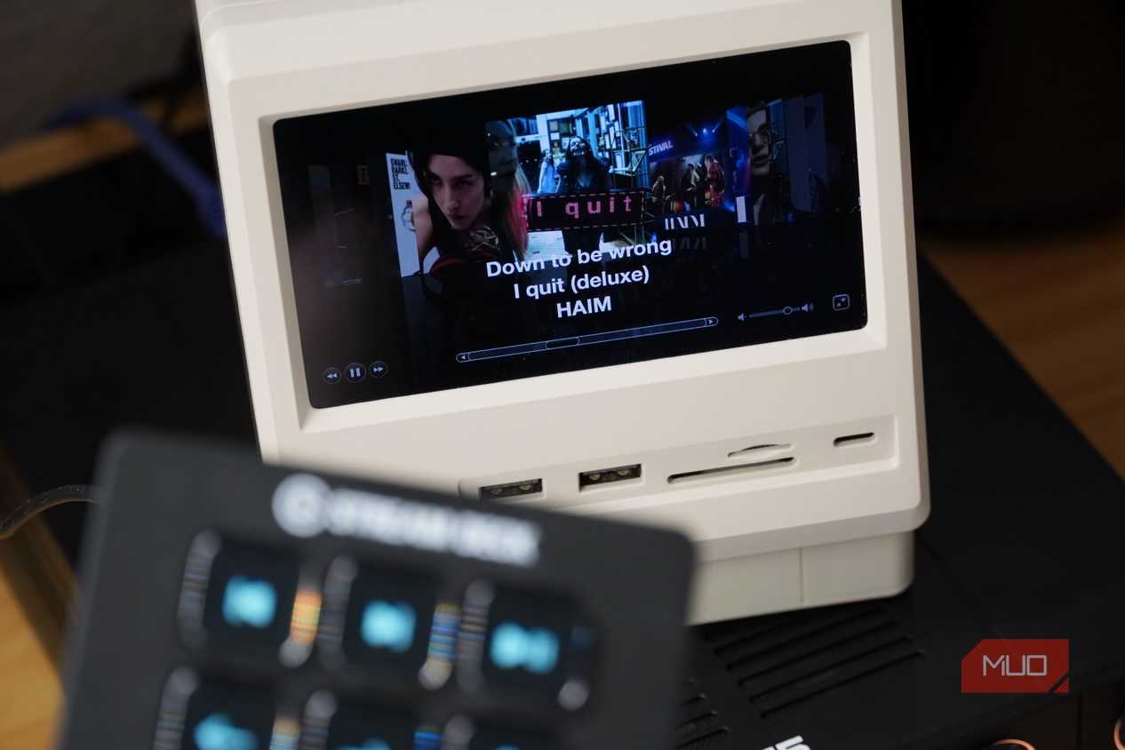 Cover Flow in iTunes with a blurred Stream Deck Mini in the foreground.