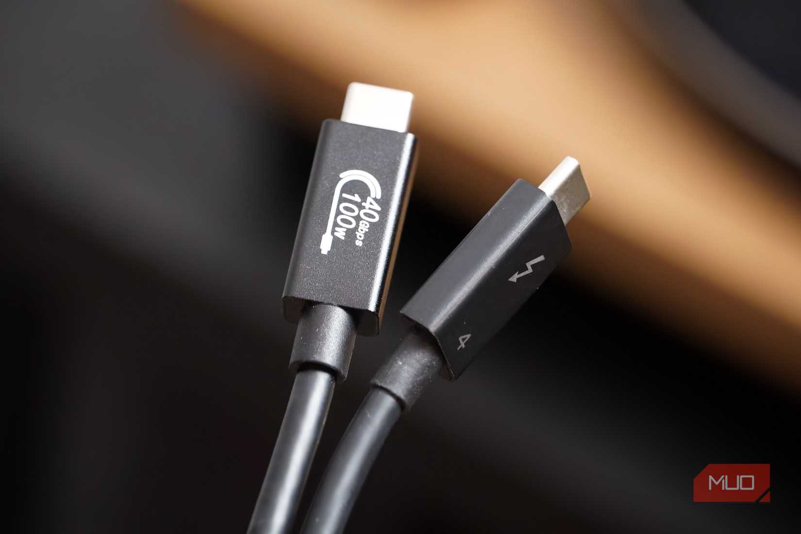 A USB4 cable next to a Thunderbolt 4 cable. 