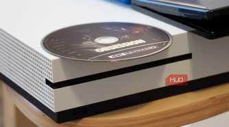 A 4K UHD disc on top of an Xbox One S.