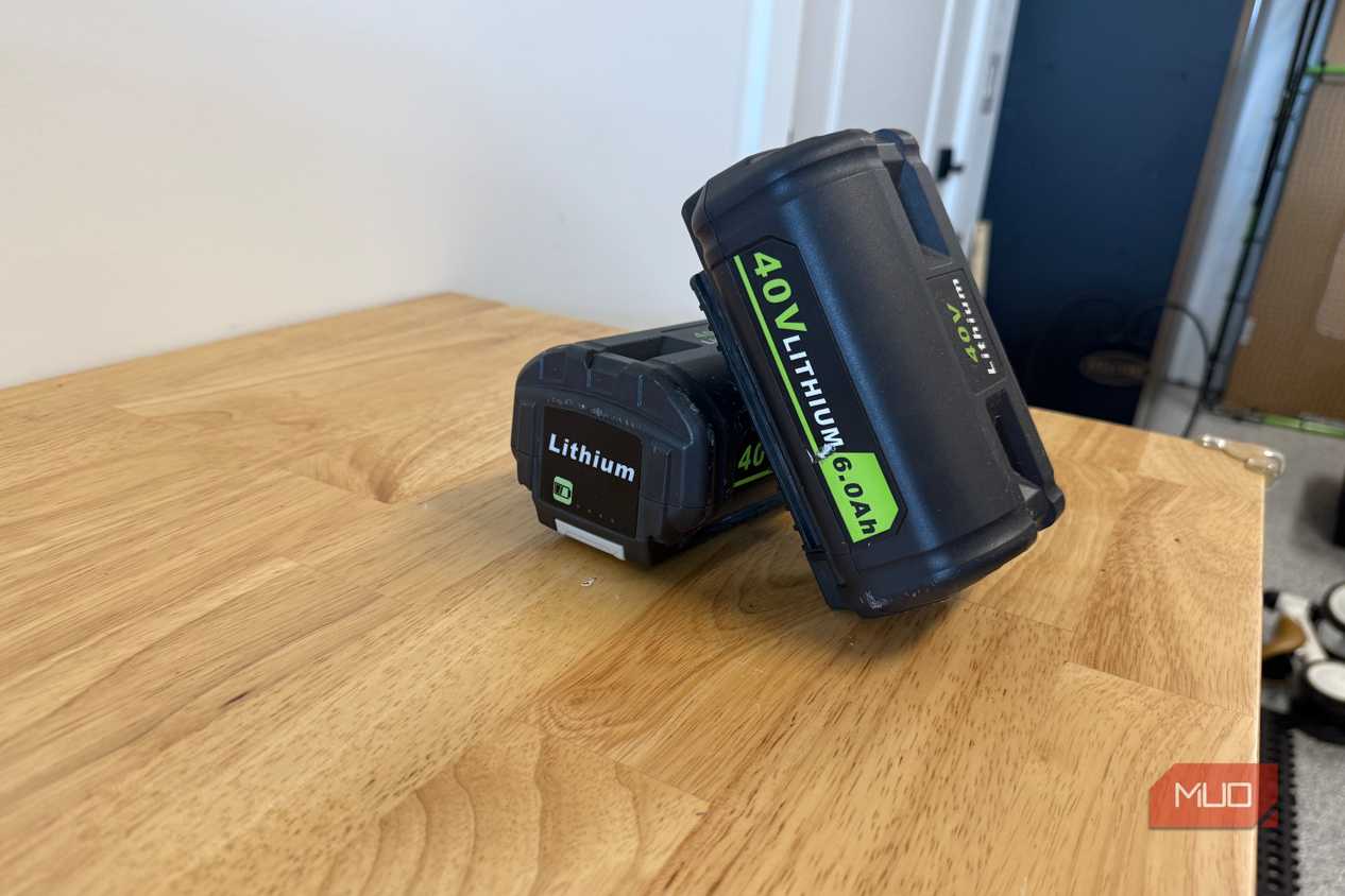 2 off-brand ryobi 40V 6.0Ah batteries leaning together on workbench