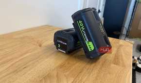 2 off-brand ryobi 40V 6.0Ah batteries leaning together on workbench