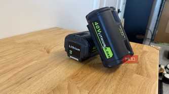 2 off-brand ryobi 40V 6.0Ah batteries leaning together on workbench