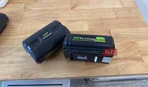 2 off-brand ryobi 40V 6.0Ah batteries lying on wooden counter