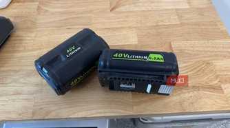 2 off-brand ryobi 40V 6.0Ah batteries lying on wooden counter