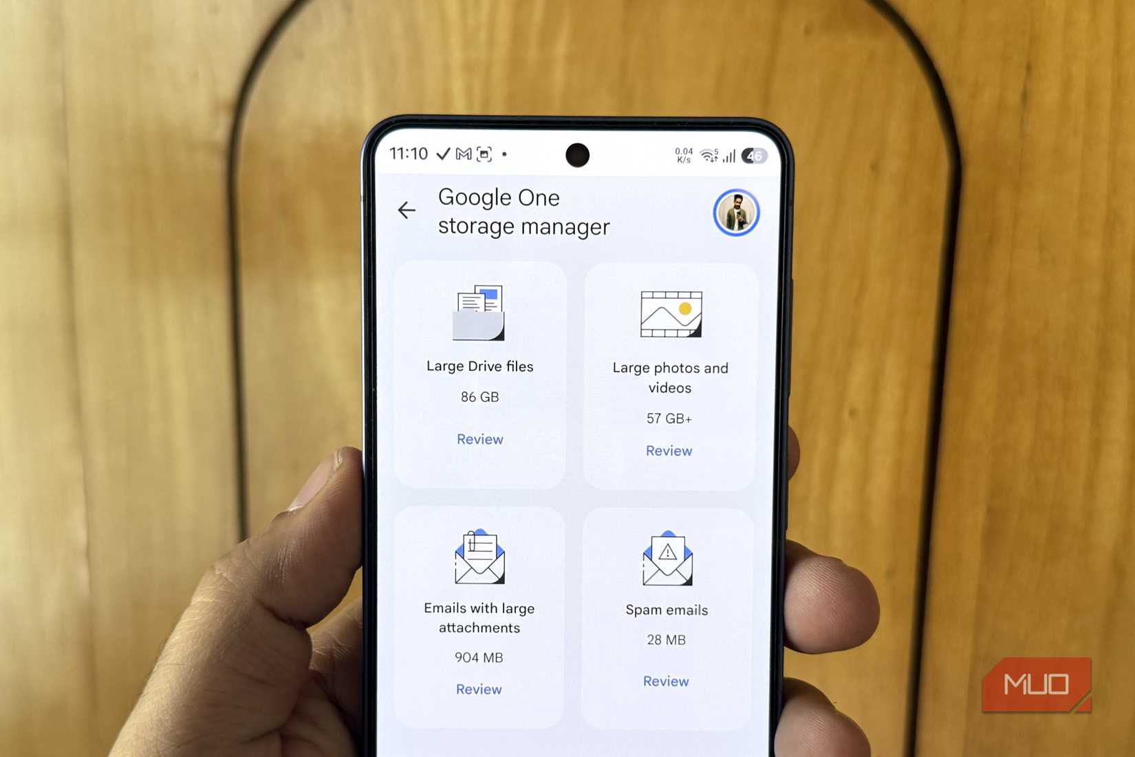 Android phone in hand showing Google Photos app
