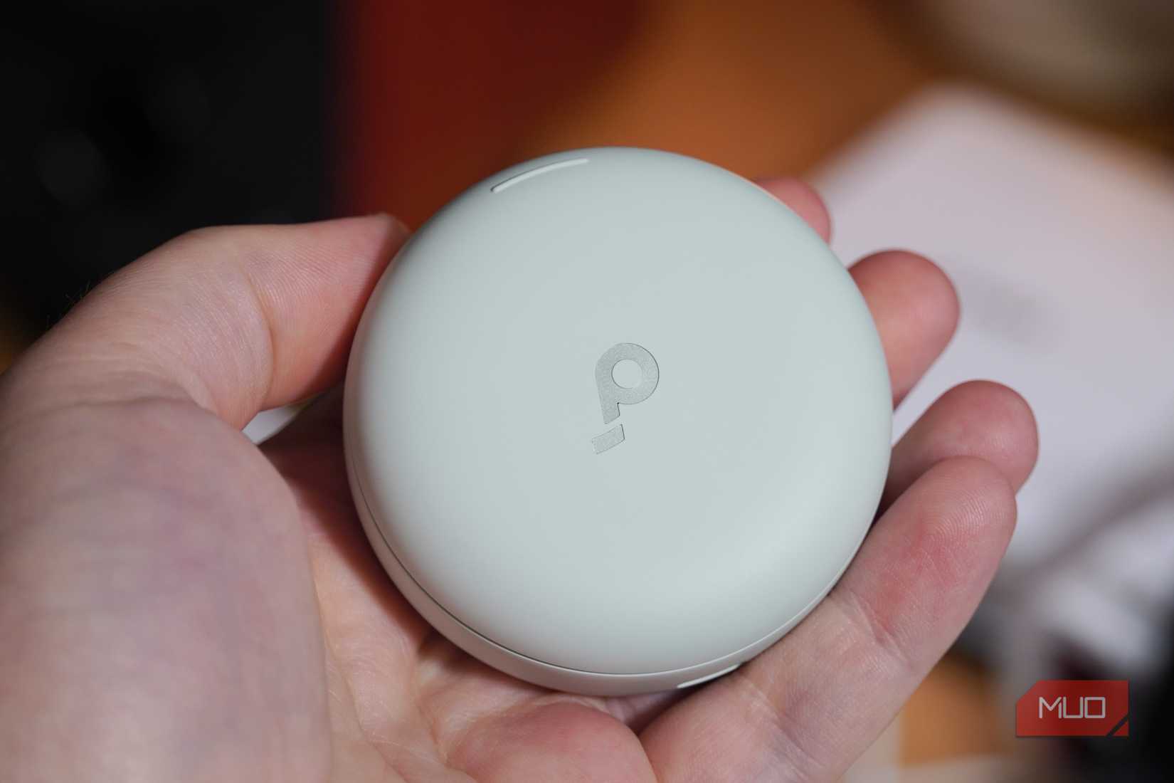 The earbud sleep case in the hand.