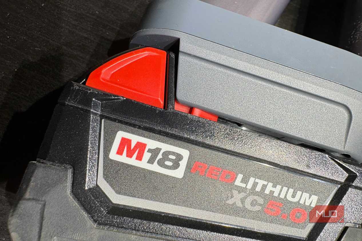A Milwaukee M18 battery attached to the Dyson V8 vacuum.