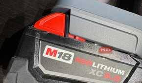 A Milwaukee M18 battery attached to the Dyson V8 vacuum.